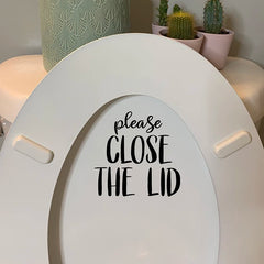 PUT ME DOWN Toilet Seat Reminder Sign | Funny Vinyl Bathroom Decal close-up view