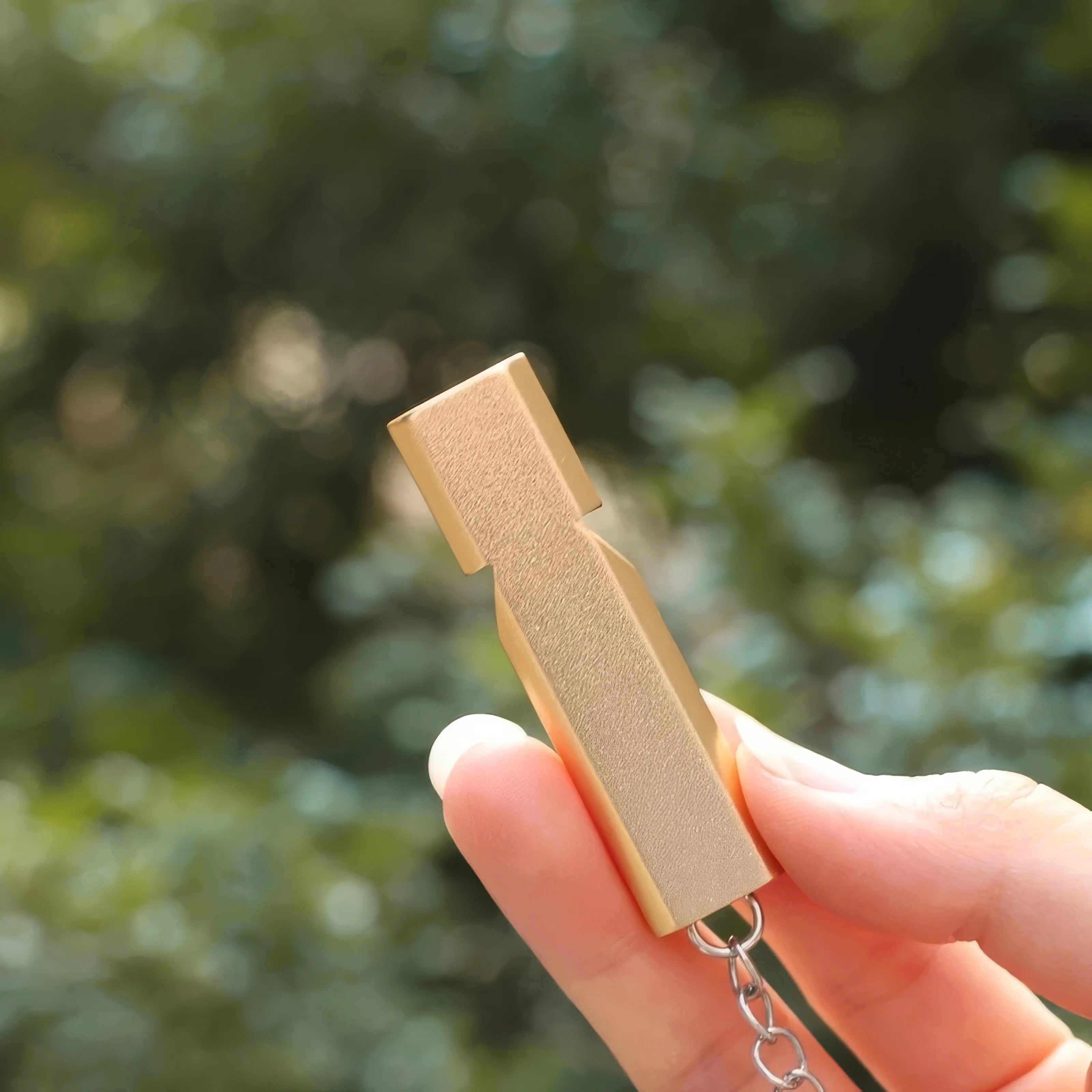 1 Gold Survival Whistle Keychain | Dual Tube Outdoor Rescue Whistle close-up view