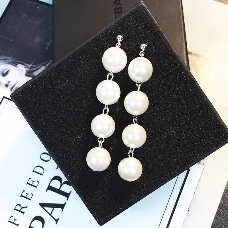 Wild Simple Pearl Bean Earrings close-up view