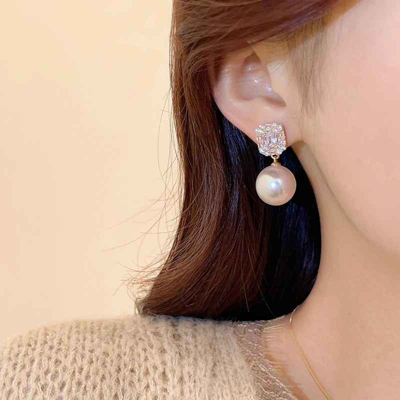 Gold Tone Pearl Drop Earrings | Shiny Crystal Pendant Jewelry detail view