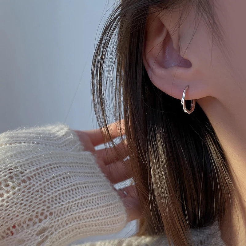 Silver Hoop Earrings | Trendy Distorted Round Earrings for Women close-up view