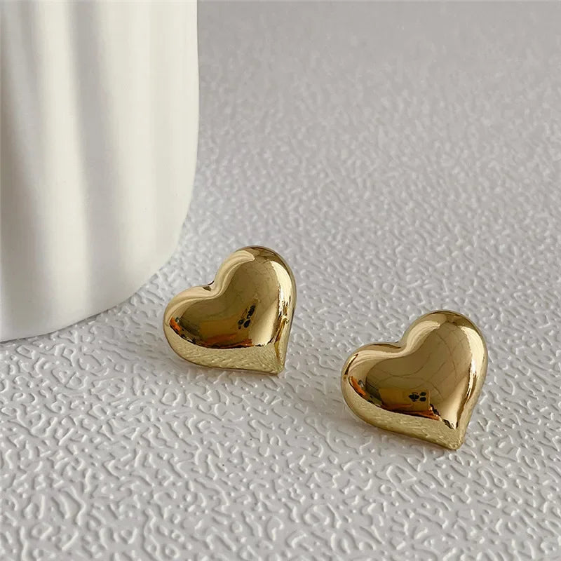 Gold Color Smooth Surface Love Heart Shaped Stud Earrings Women Minimalist Fashion Gir close-up view