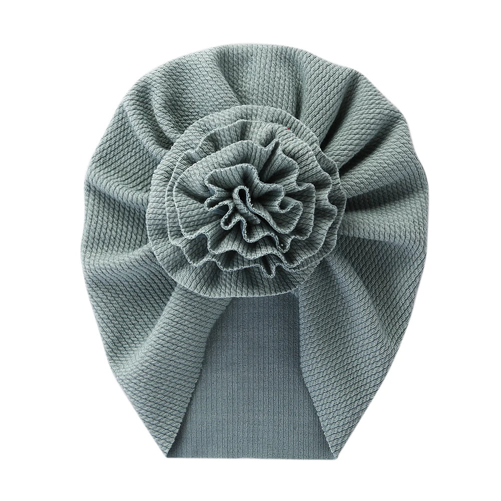 Big Blossom Flower Ribbed Turban Baby Hat | Soft Cotton Topknot Bonnet for Newborns a lifestyle view