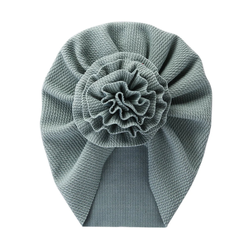 Big Blossom Flower Ribbed Turban Baby Hat | Soft Cotton Topknot Bonnet for Newborns a lifestyle view
