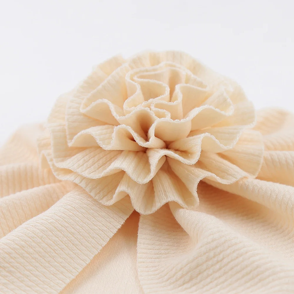 Big Blossom Flower Ribbed Turban Baby Hat | Soft Cotton Topknot Bonnet for Newborns a lifestyle view