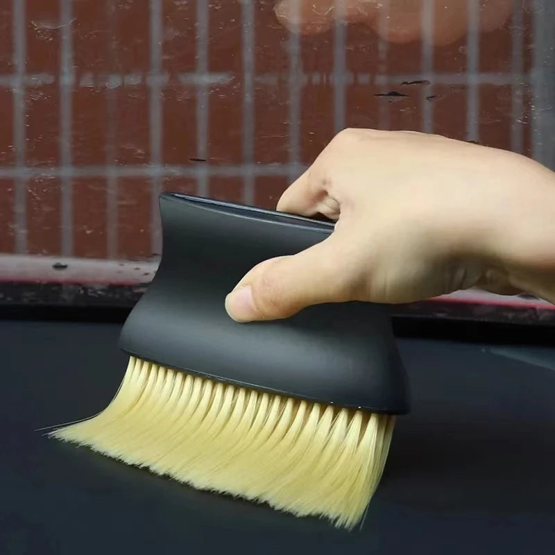 Car interior sweeping dust soft brush car wash tool artifact car interior gap dust bru close-up view