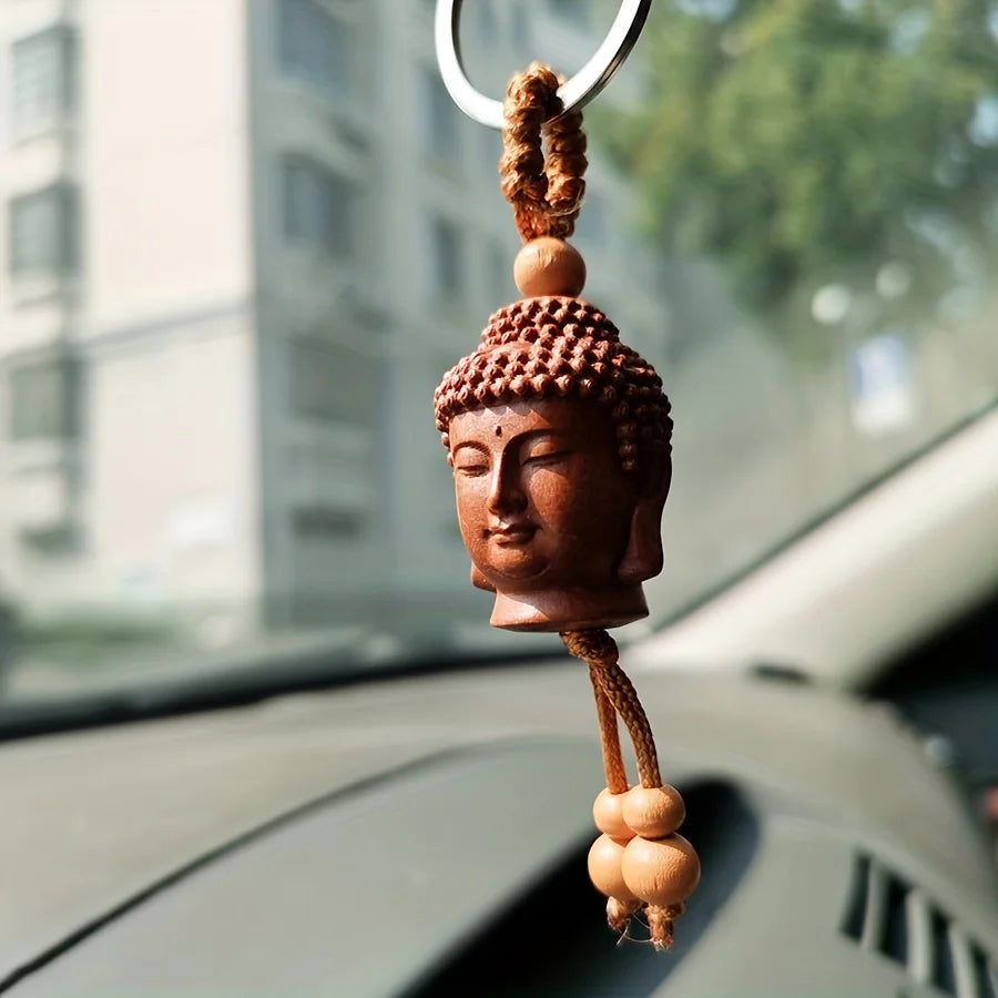 Buddha Head Carved Wood Keychain | Peach Wood Key Ring close-up view