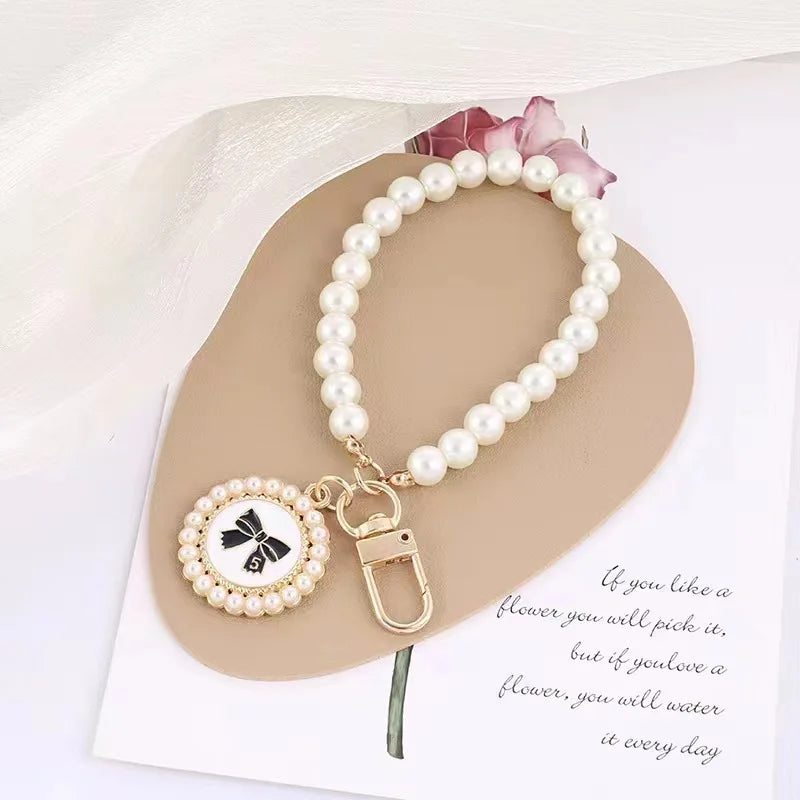 ZAKOL Cute Pearl Keychain for Women Girls Shiny Pearl Bead Shell Phone Bag Backpack C lifestyle view