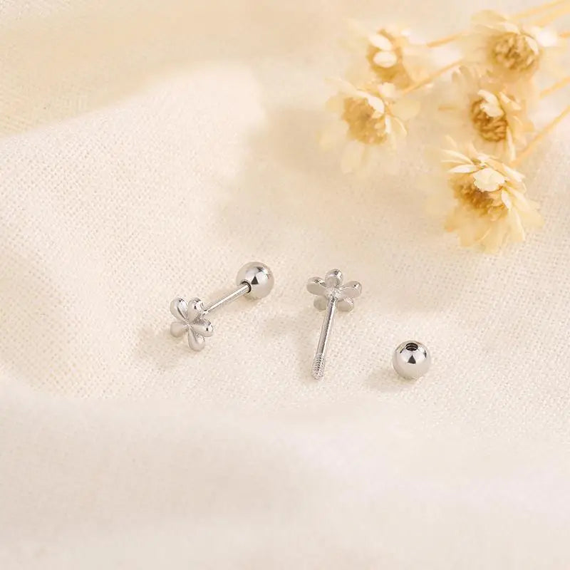 EVSIPOL Tiny Stainless Steel Screw Back Flower Stud Earrings for Women Girls Simple C lifestyle view