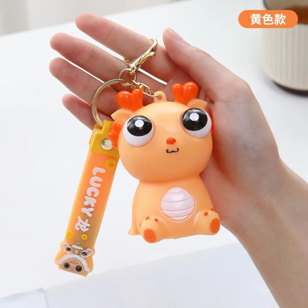 Big Eyed Dragon Squishy Toy | Pop Eyes Fidget Keychain for Stress Relief lifestyle view